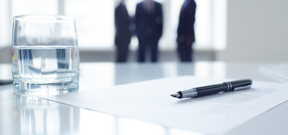 Pen on document and glass of water